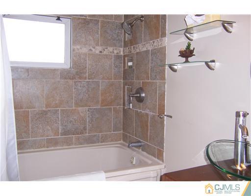 51 Westminster Road Colonia, NJ 07067 - Photo 14 of 25 a bathroom with a bath tub