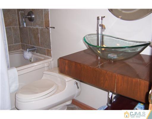 51 Westminster Road Colonia, NJ 07067 - Photo 15 of 25 a bathroom with a toilet and a sink