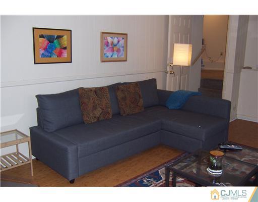 51 Westminster Road Colonia, NJ 07067 - Photo 16 of 25 a living room with furniture and a flat screen tv