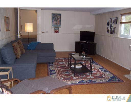51 Westminster Road Colonia, NJ 07067 - Photo 17 of 25 a living room with furniture a rug and a window
