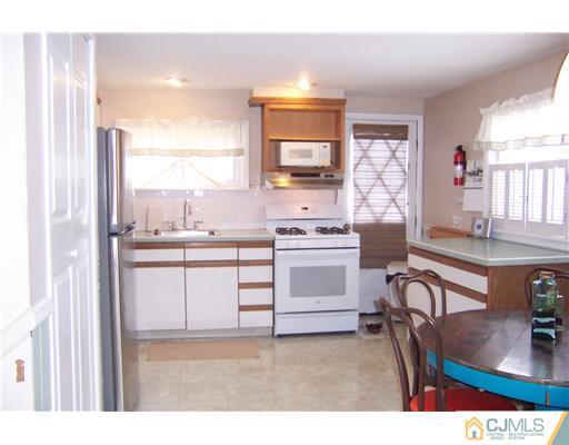 51 Westminster Road Colonia, NJ 07067 - Photo 5 of 25 a kitchen with a stove a sink and a refrigerator