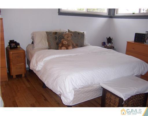 51 Westminster Road Colonia, NJ 07067 - Photo 10 of 25 a bedroom with a bed and a night stand