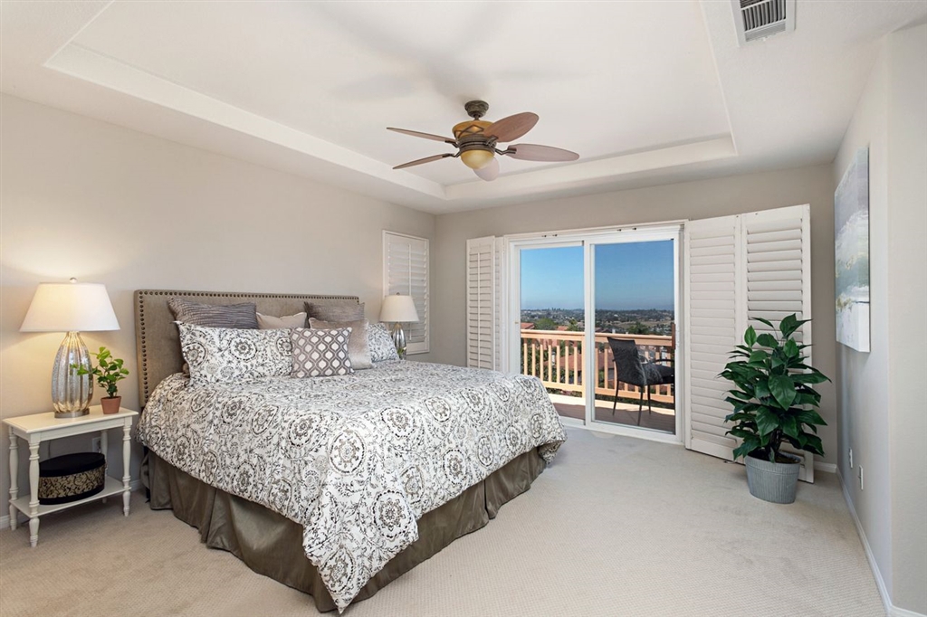 3530 Harwich Drive Carlsbad, CA 92010 - Photo 17 of 25 a bedroom with a large bed and a potted plant