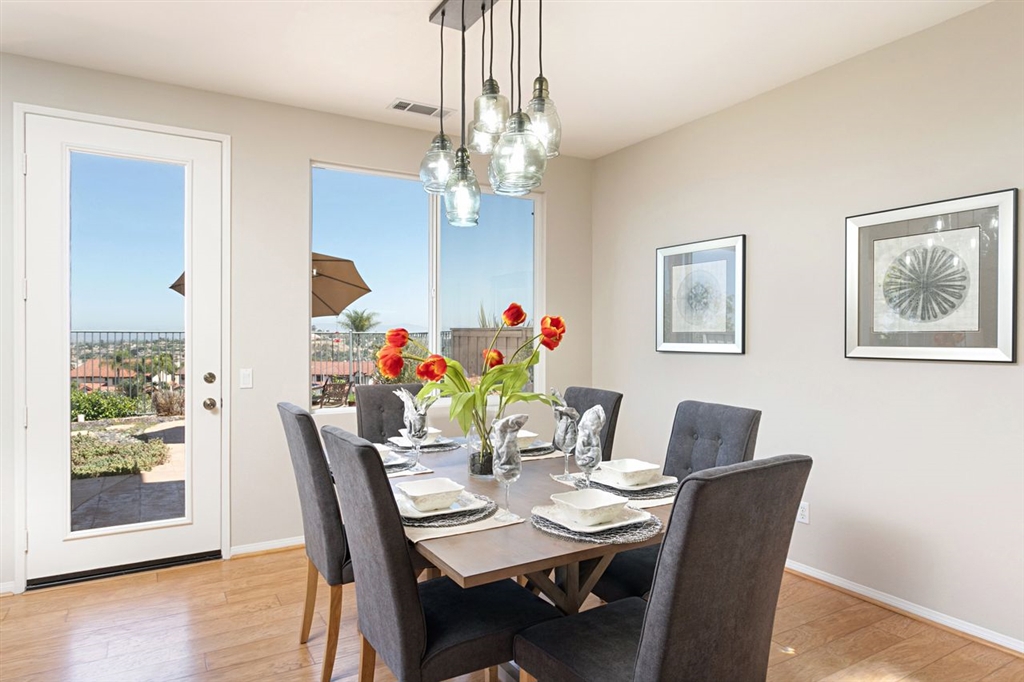 3530 Harwich Drive Carlsbad, CA 92010 - Photo 5 of 25 a dining room with furniture potted plants and wooden floor