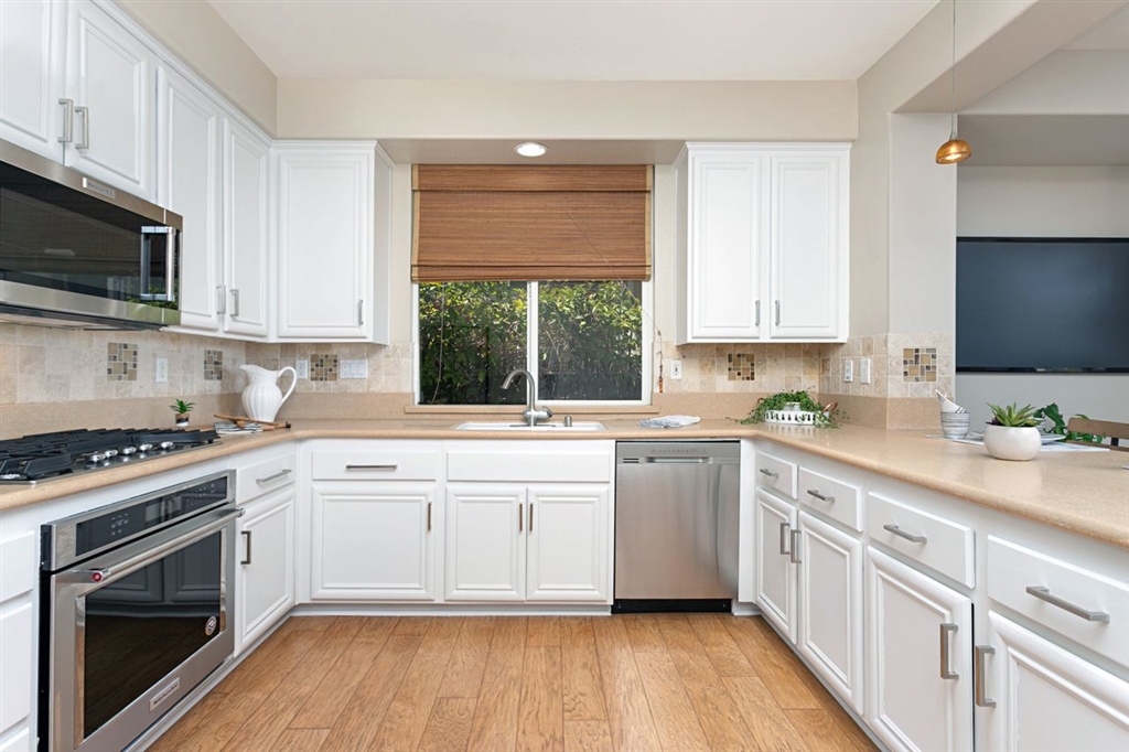 3530 Harwich Drive Carlsbad, CA 92010 - Photo 6 of 25 a kitchen with stainless steel appliances granite countertop a stove and a sink