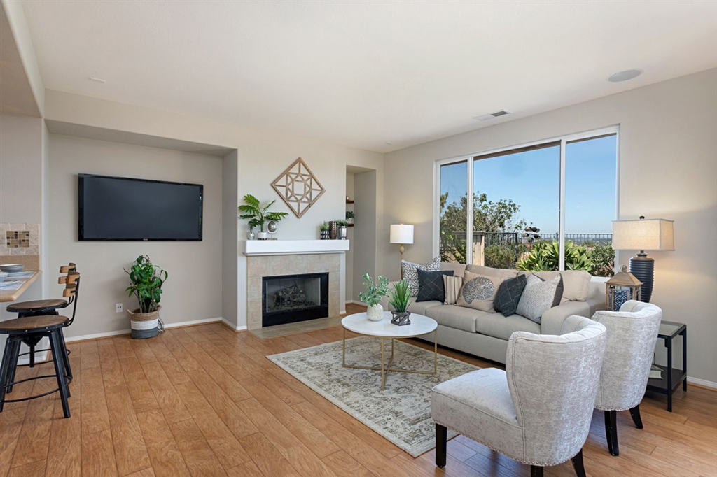 3530 Harwich Drive Carlsbad, CA 92010 - Photo 25 of 25 a living room with furniture a flat screen tv and a fireplace