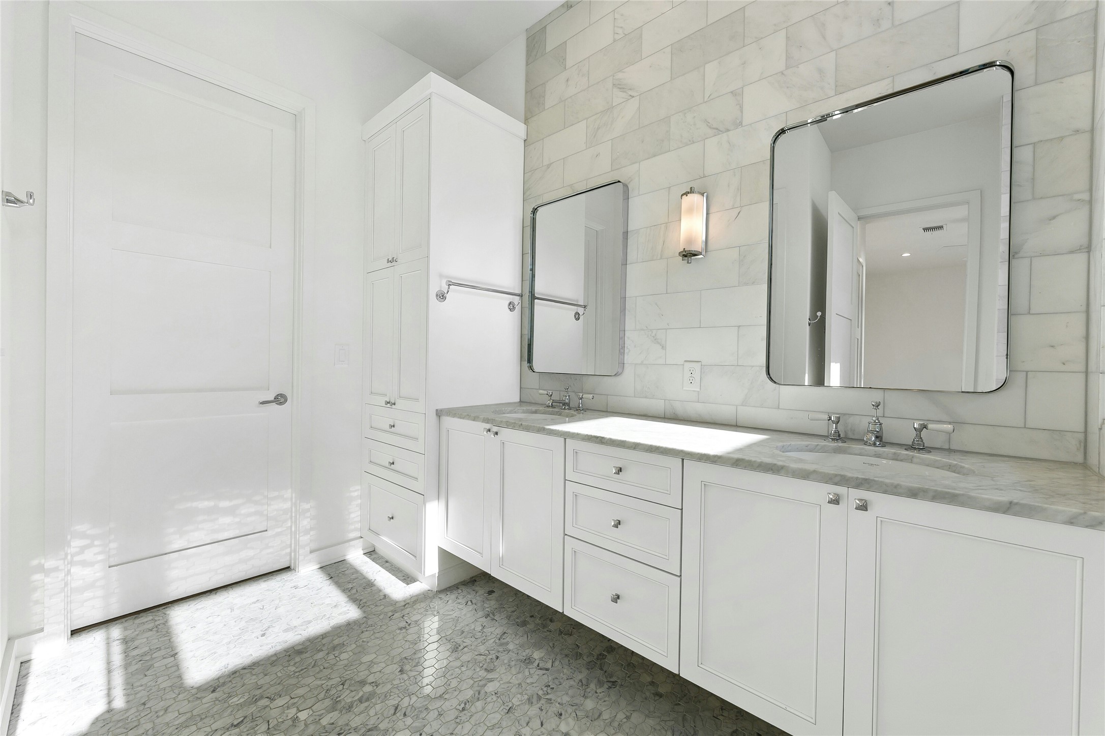 2518 Sutherland Street Austin, TX 78746 - Photo 17 of 30 Marble tile floors complement dual vanities and sleek storage in this contemporary bathroom.