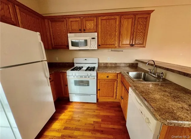 a kitchen with a refrigerator sink and stove
