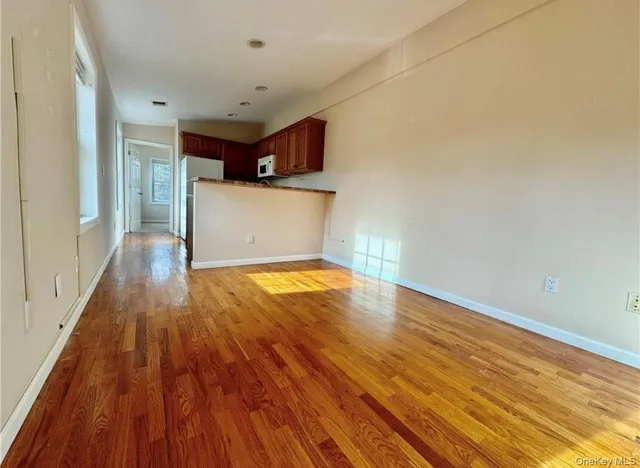 a view of a room with wooden floor
