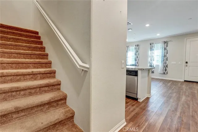 a view of entryway and hall with wooden floor