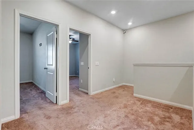 an empty room with closet and wooden door