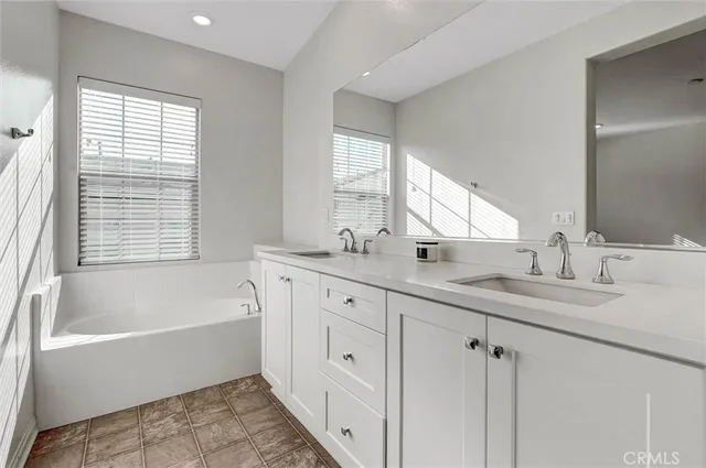 a bath tub sitting in a bathroom next to a window