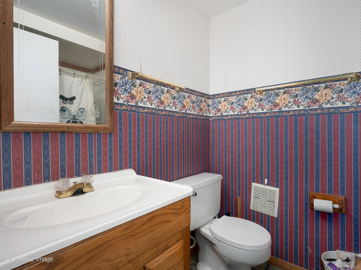 18646 Palmer Circle Homewood, IL 60430 - Photo 12 of 17 a bathroom with a toilet a sink and a shower curtain