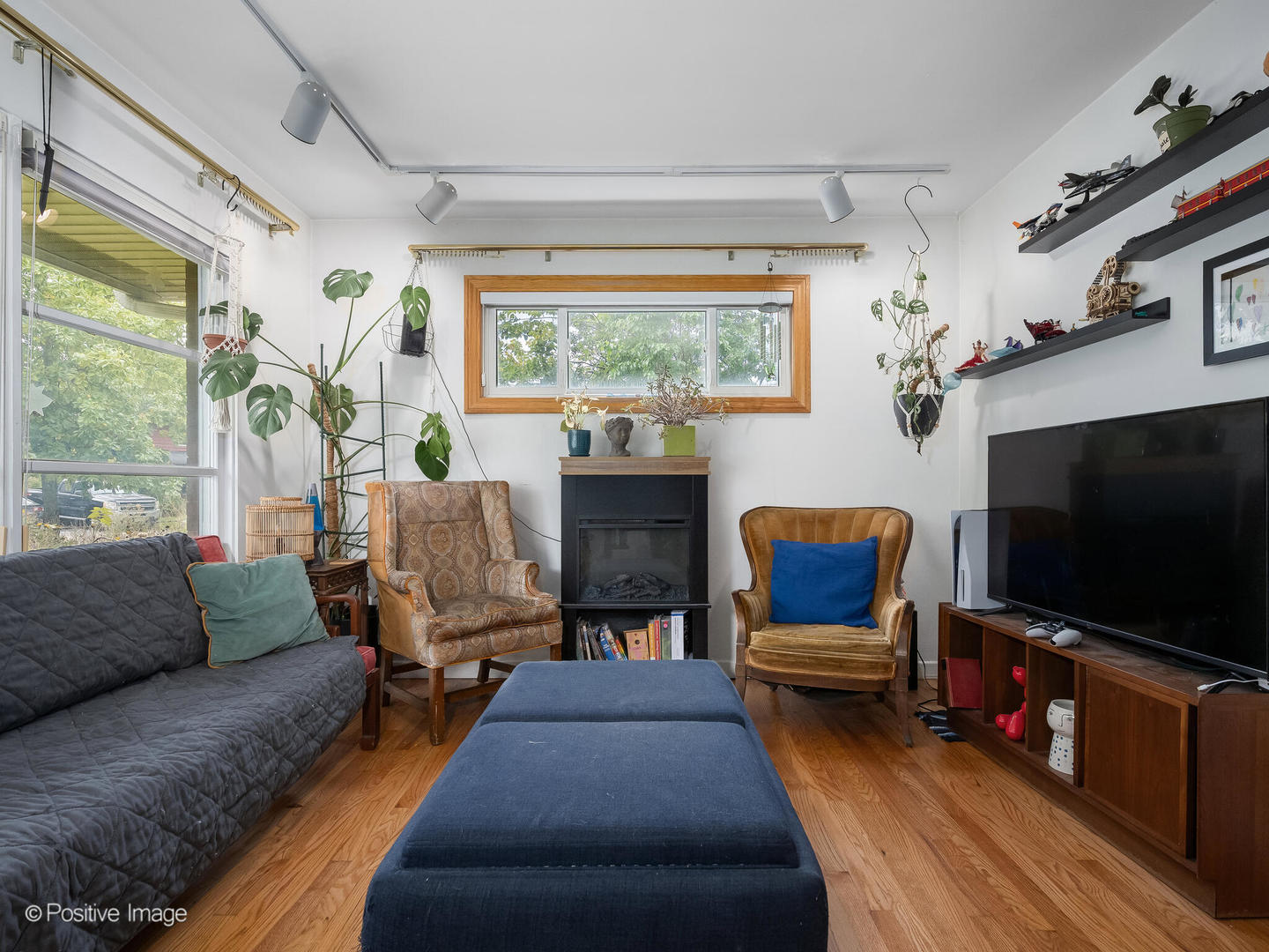 18646 Palmer Circle Homewood, IL 60430 - Photo 3 of 17 a living room with furniture a flat screen tv and a large window