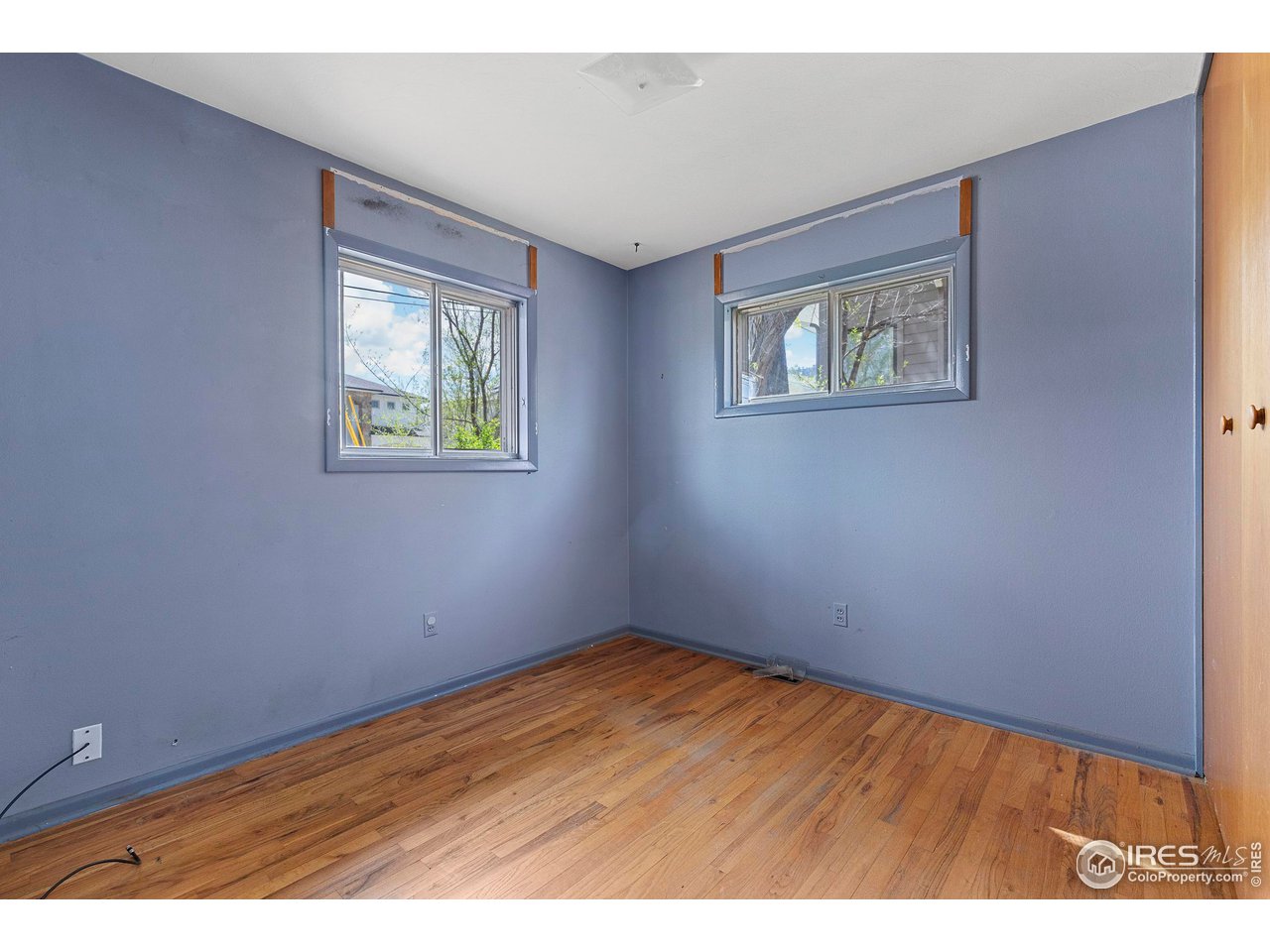 855 Union Avenue Boulder, CO 80304 - Photo 11 of 21 an empty room with wooden floor and windows