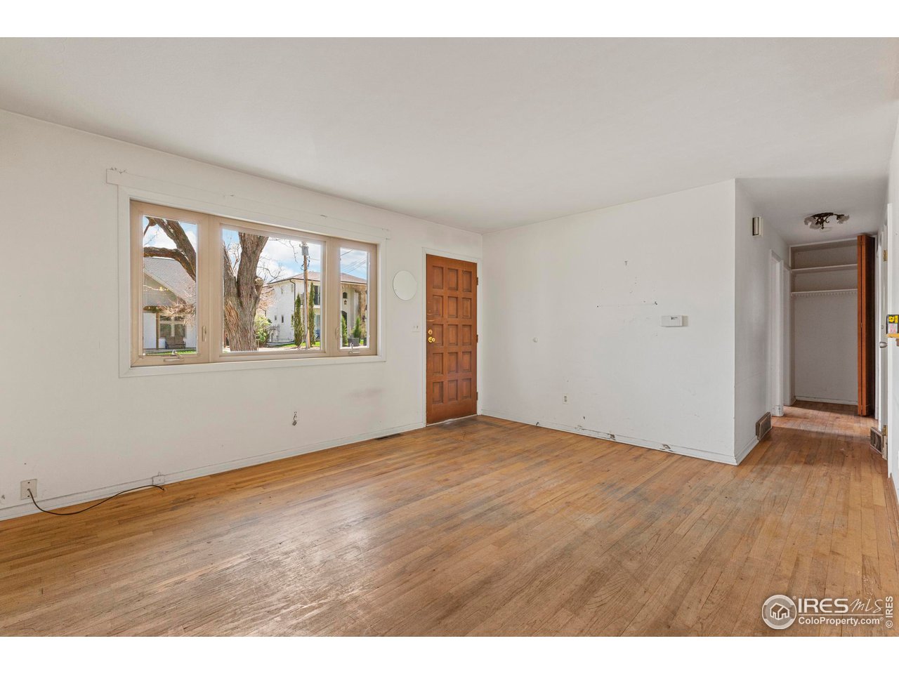 855 Union Avenue Boulder, CO 80304 - Photo 3 of 21 a view of an empty room with window and wooden floor