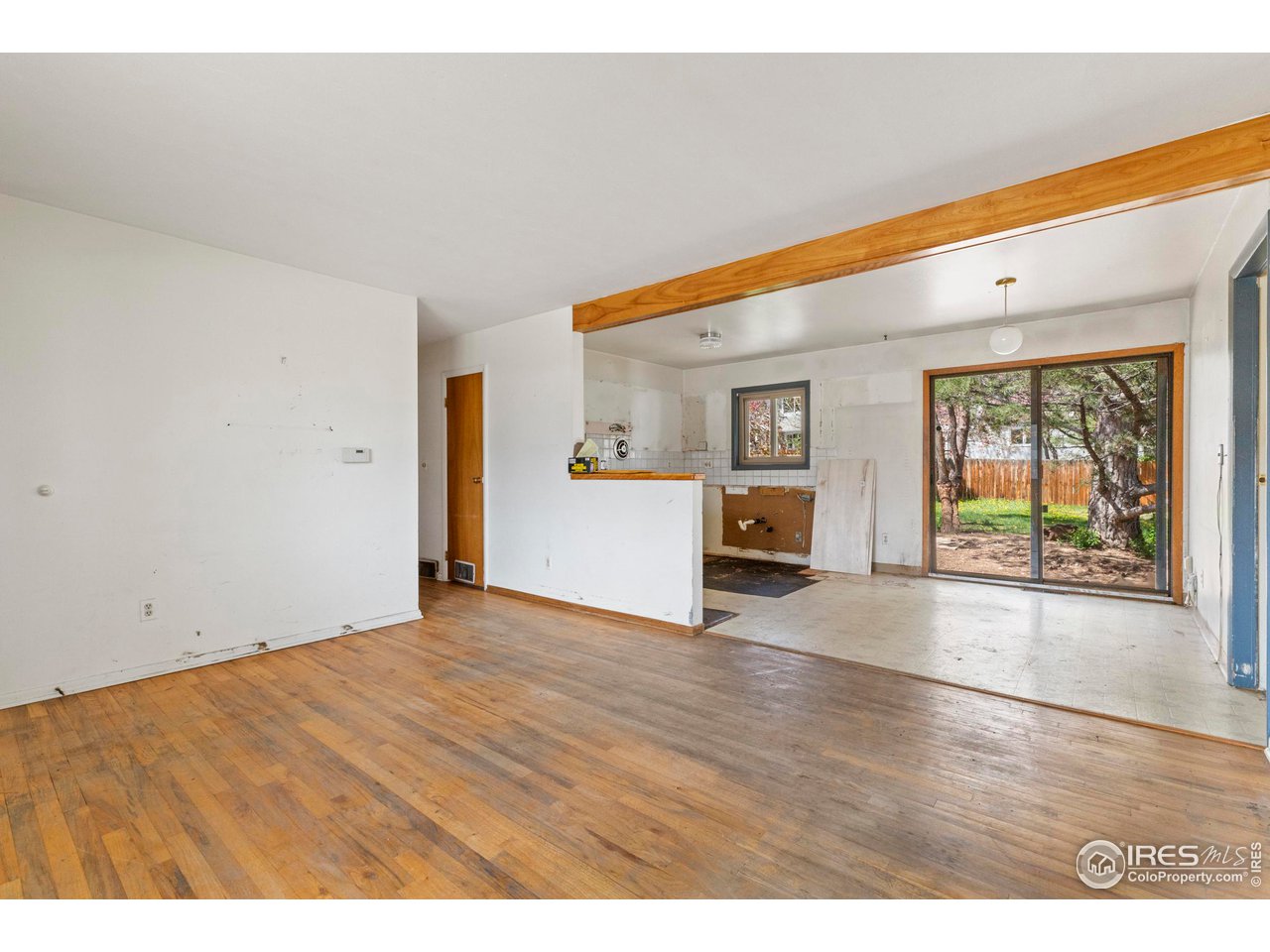 855 Union Avenue Boulder, CO 80304 - Photo 6 of 21 a view of an empty room with a window and wooden floor