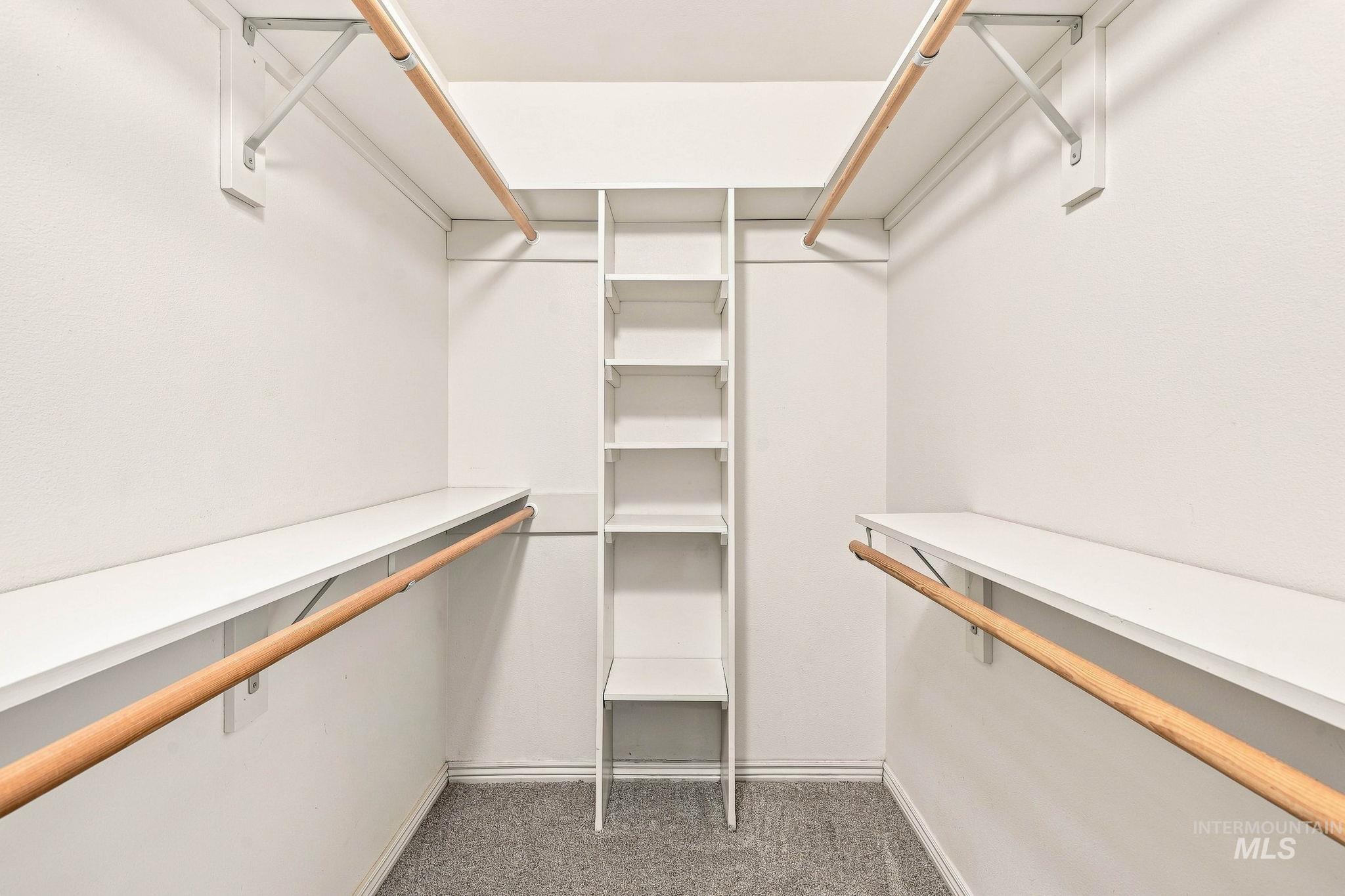 2442 West Hill Road Boise, ID 83702 - Photo 23 of 48 Walk-in closet featuring built-in shelving, multiple hanging rods, and integrated storage