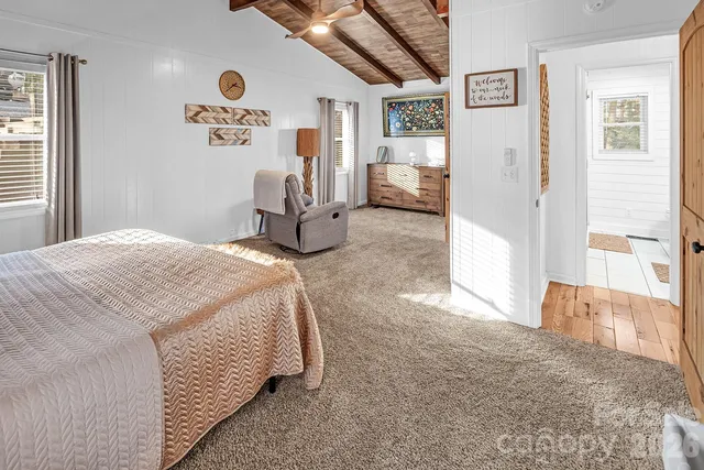a spacious bedroom with a bed and a cabinets