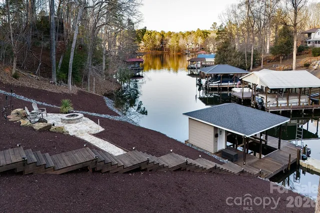 a view of house with outdoor space and lake view