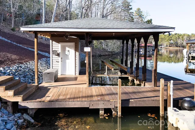 a view of house with a swimming pool and sitting area