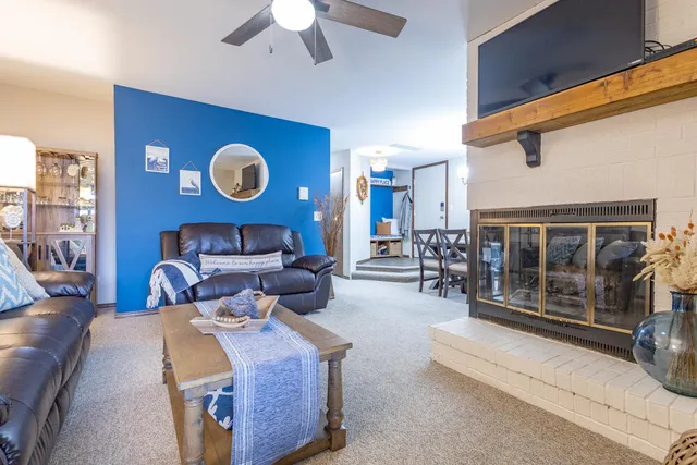 a bedroom with furniture and a large window