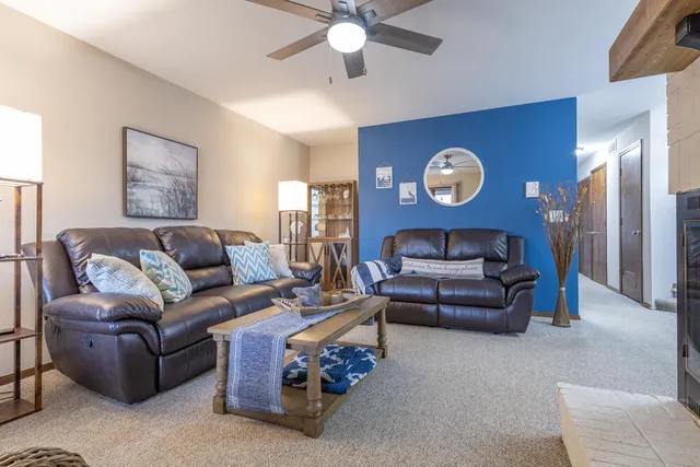 a living room with furniture and a chandelier