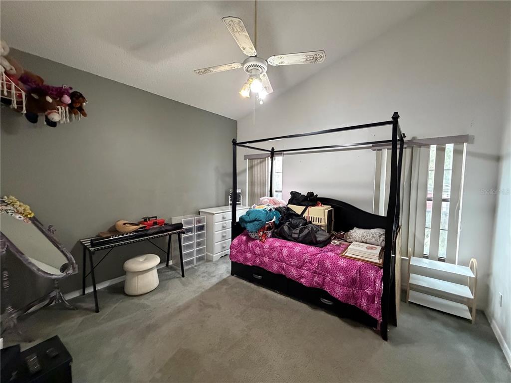 9 Hialeah Drive Ocala, FL 34482 - Photo 25 of 41 a bedroom with a bed and a chandelier