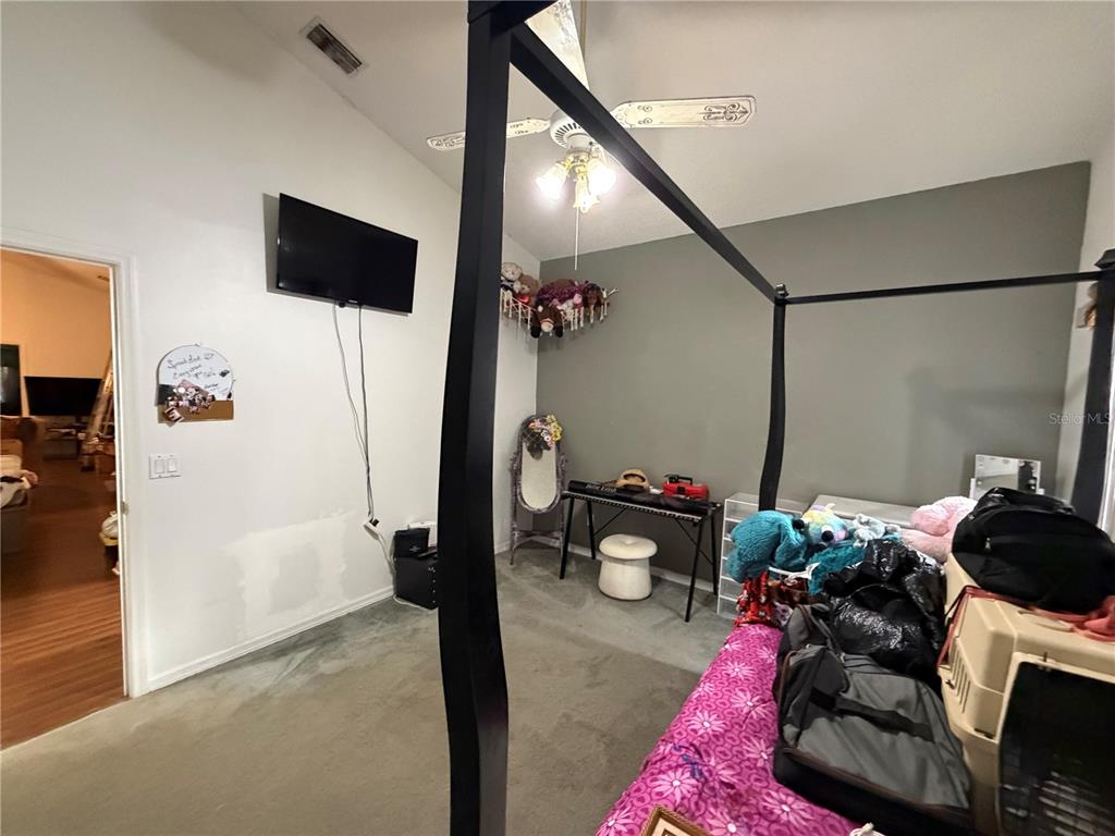 9 Hialeah Drive Ocala, FL 34482 - Photo 27 of 41 a living room with furniture and a flat screen tv