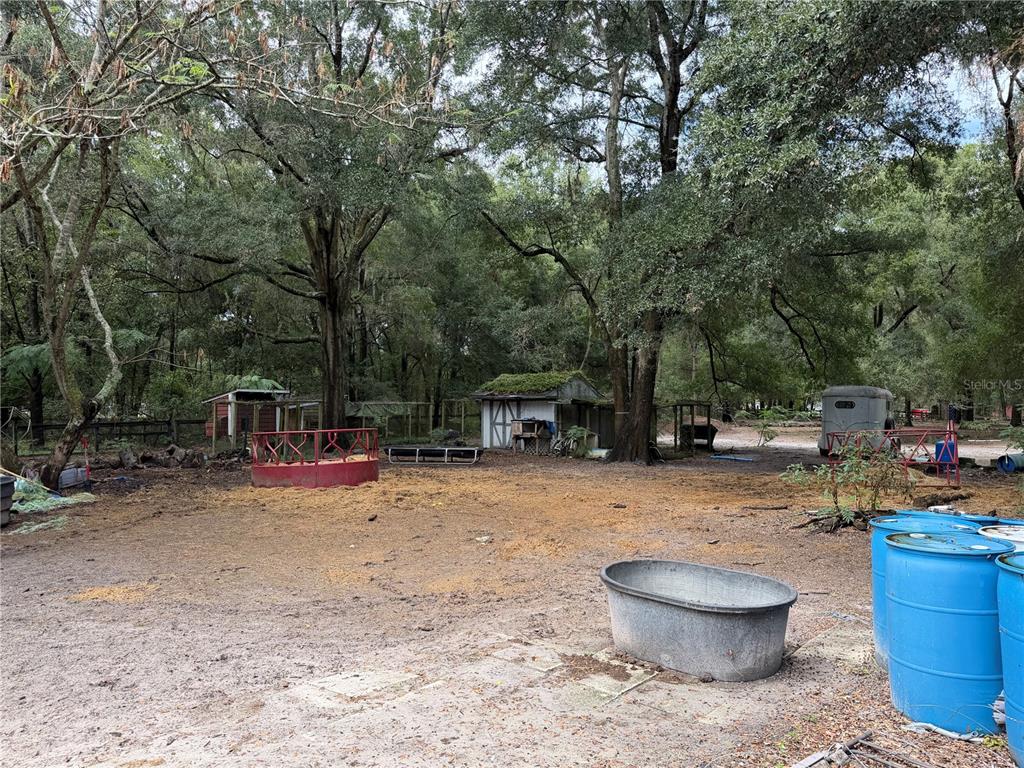 9 Hialeah Drive Ocala, FL 34482 - Photo 37 of 41 a backyard of a house with fire pit and barbeque oven