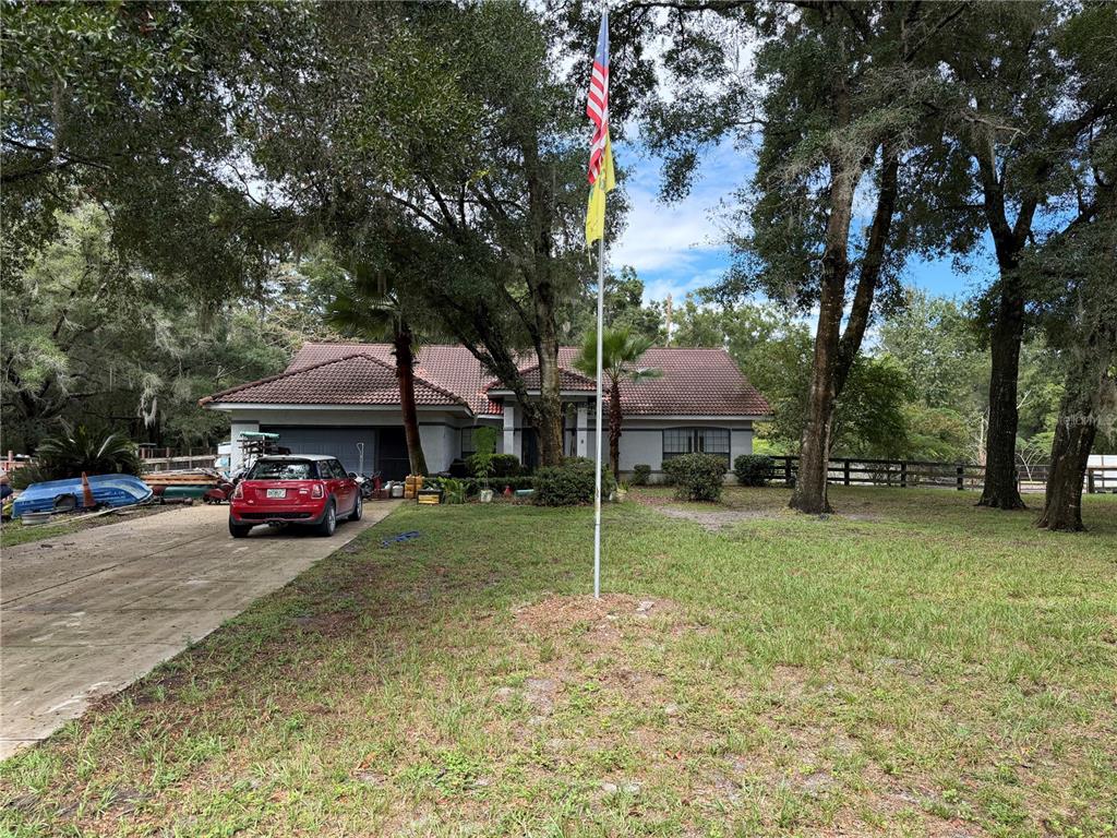 9 Hialeah Drive Ocala, FL 34482 - Photo 4 of 41 a view of a house with a yard and a large tree