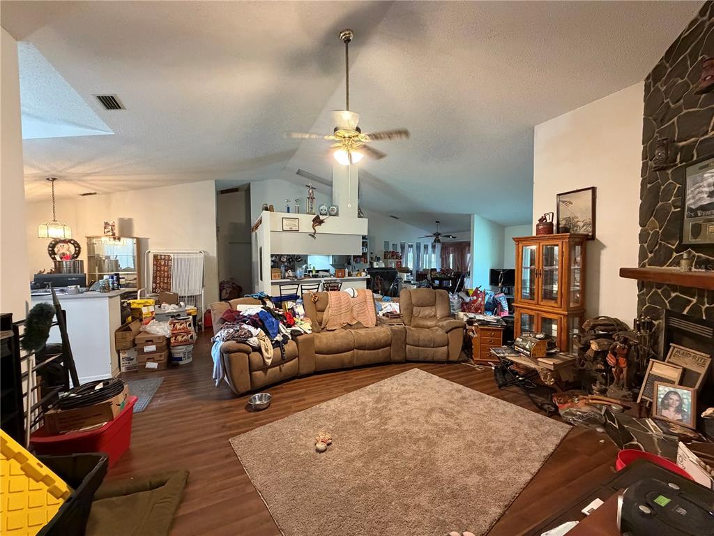 9 Hialeah Drive Ocala, FL 34482 - Photo 9 of 41 a living room with furniture a fireplace and a chandelier