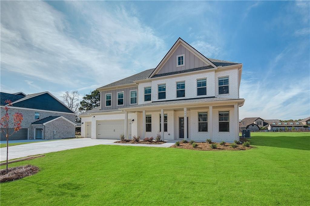 154 Haverling Pass Hampton, GA 30228 - Photo 2 of 36 a front view of a house with a yard