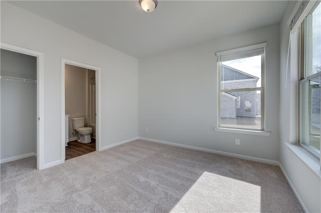 154 Haverling Pass Hampton, GA 30228 - Photo 21 of 36 an empty room with windows and closet