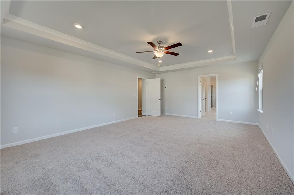 154 Haverling Pass Hampton, GA 30228 - Photo 27 of 36 a view of an empty room with a ceiling fan