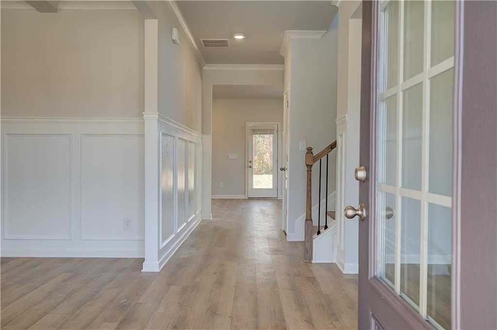 154 Haverling Pass Hampton, GA 30228 - Photo 4 of 36 a view of a hallway with wooden floor and entryway