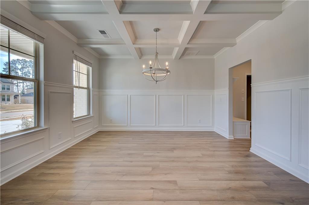 154 Haverling Pass Hampton, GA 30228 - Photo 5 of 36 a view of an empty room with a window and wooden floor