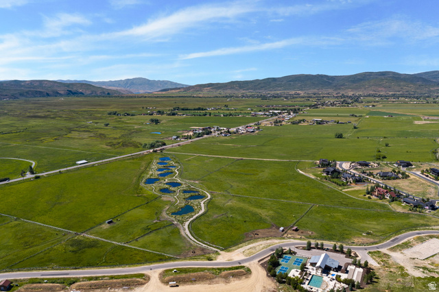 910 Wasatch Drive Kamas, UT 84036 - Photo 21 of 36 Expansive green landscape featuring multiple ponds, distant mountain ranges, and residential areas