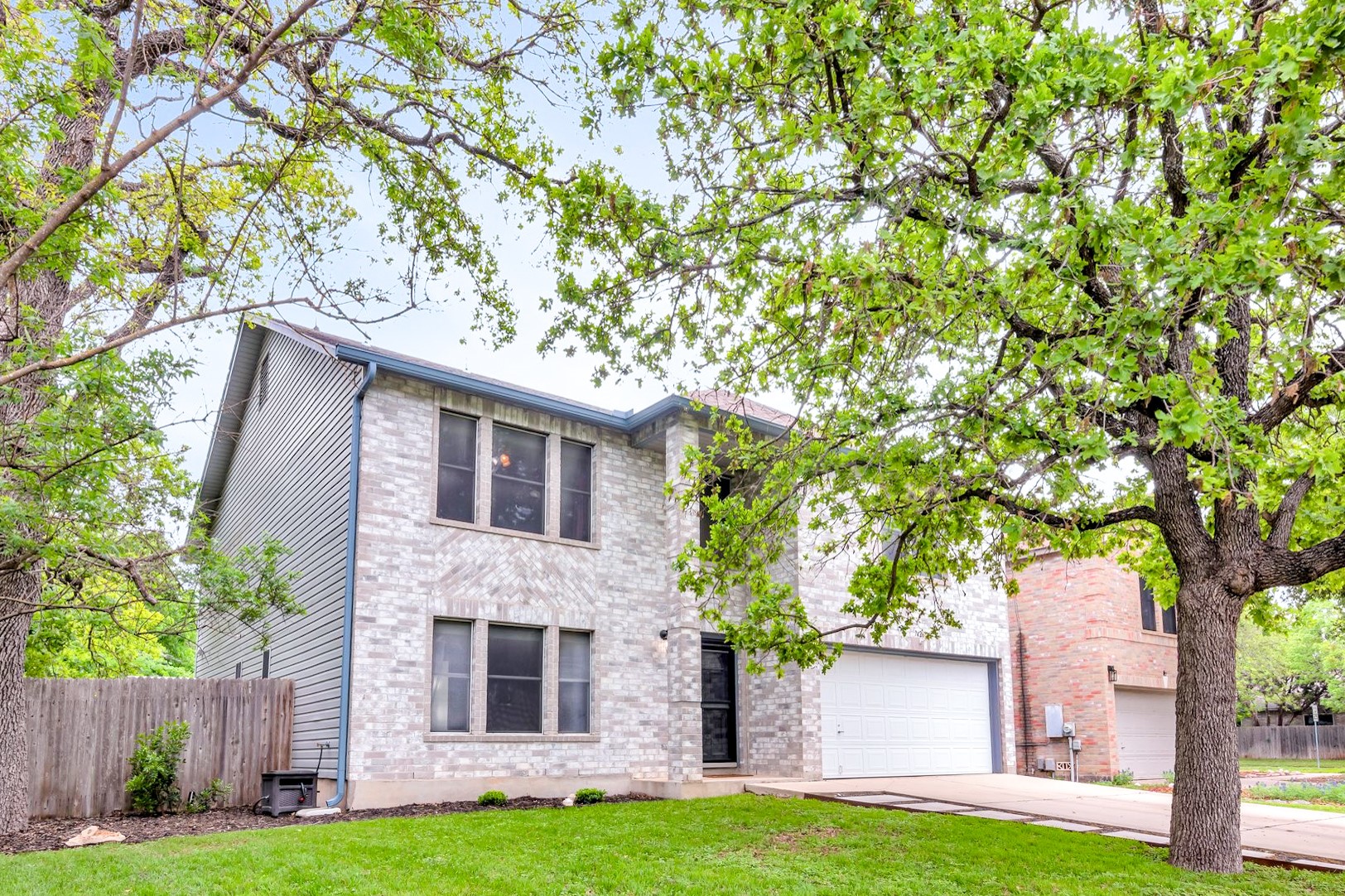 7426 Pusch Ridge Loop Austin, TX 78749 - Photo 1 of 1 a front view of a house with a garden and trees