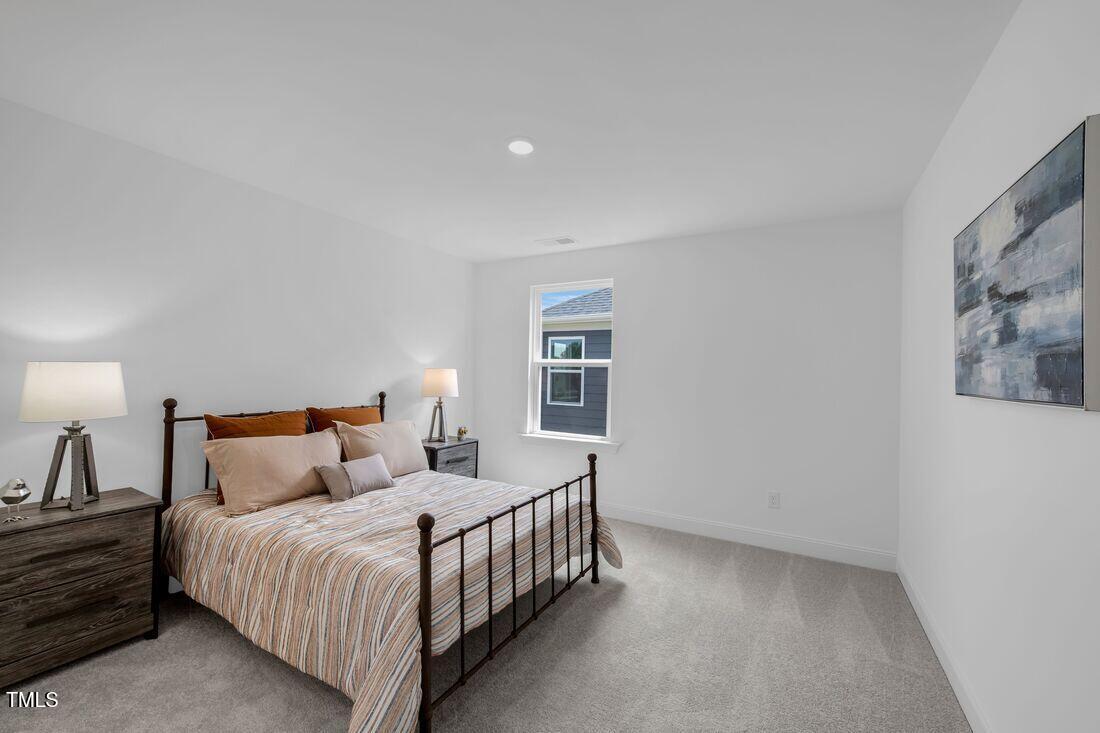 249 Tidal Pool Way Cary, NC 27519 - Photo 11 of 23 a bedroom with a bed and a night stand