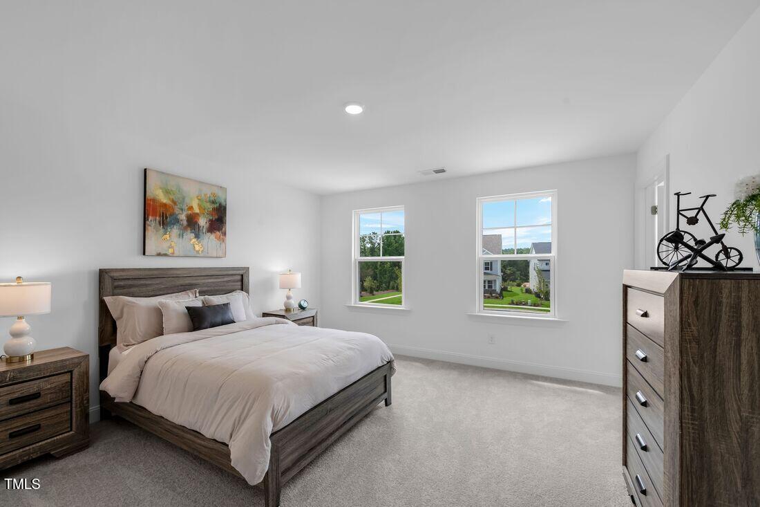 249 Tidal Pool Way Cary, NC 27519 - Photo 12 of 23 a bedroom with a large bed and a window
