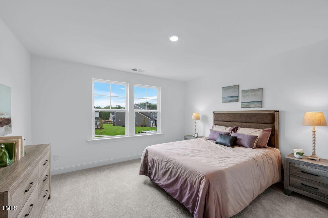 249 Tidal Pool Way Cary, NC 27519 - Photo 13 of 23 a bedroom with a bed and a window