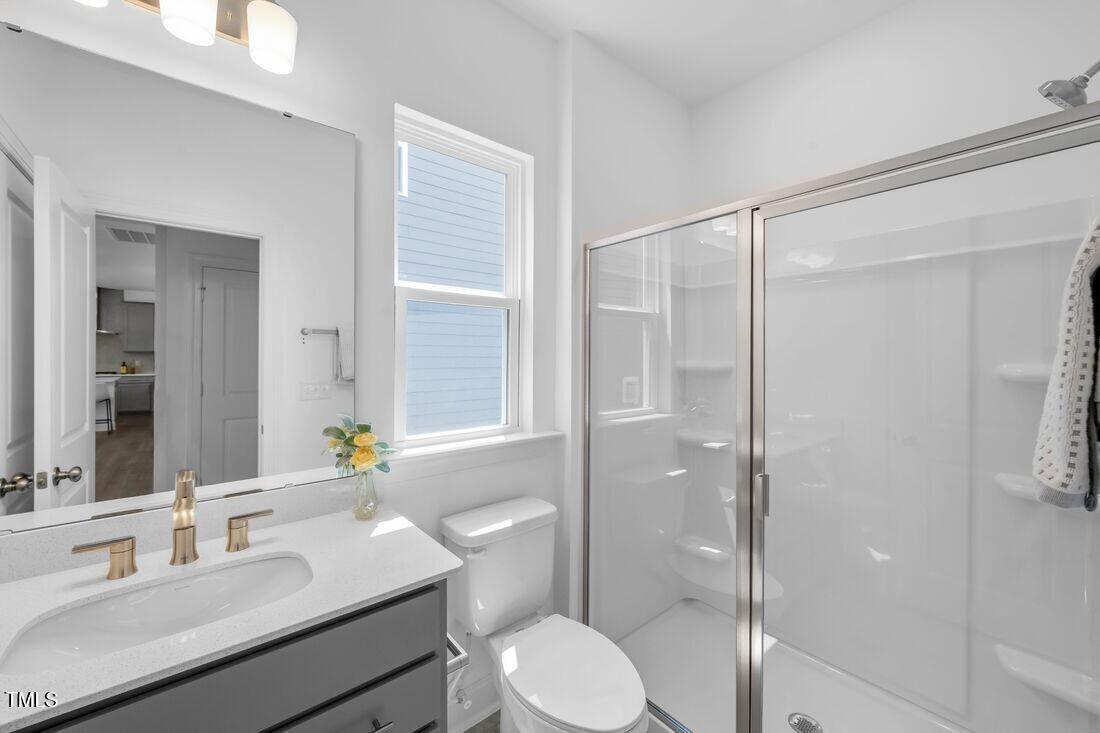 249 Tidal Pool Way Cary, NC 27519 - Photo 15 of 23 a bathroom with a sink toilet vanity and shower