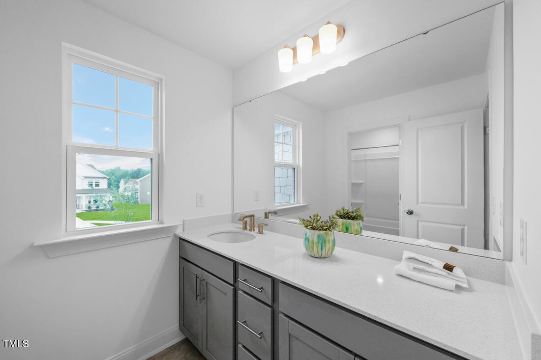 249 Tidal Pool Way Cary, NC 27519 - Photo 16 of 23 a bathroom with a double vanity sink and a mirror