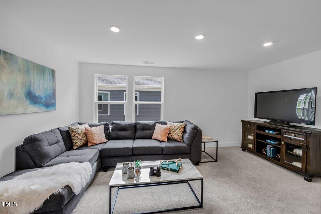 249 Tidal Pool Way Cary, NC 27519 - Photo 4 of 23 a living room with furniture and a flat screen tv