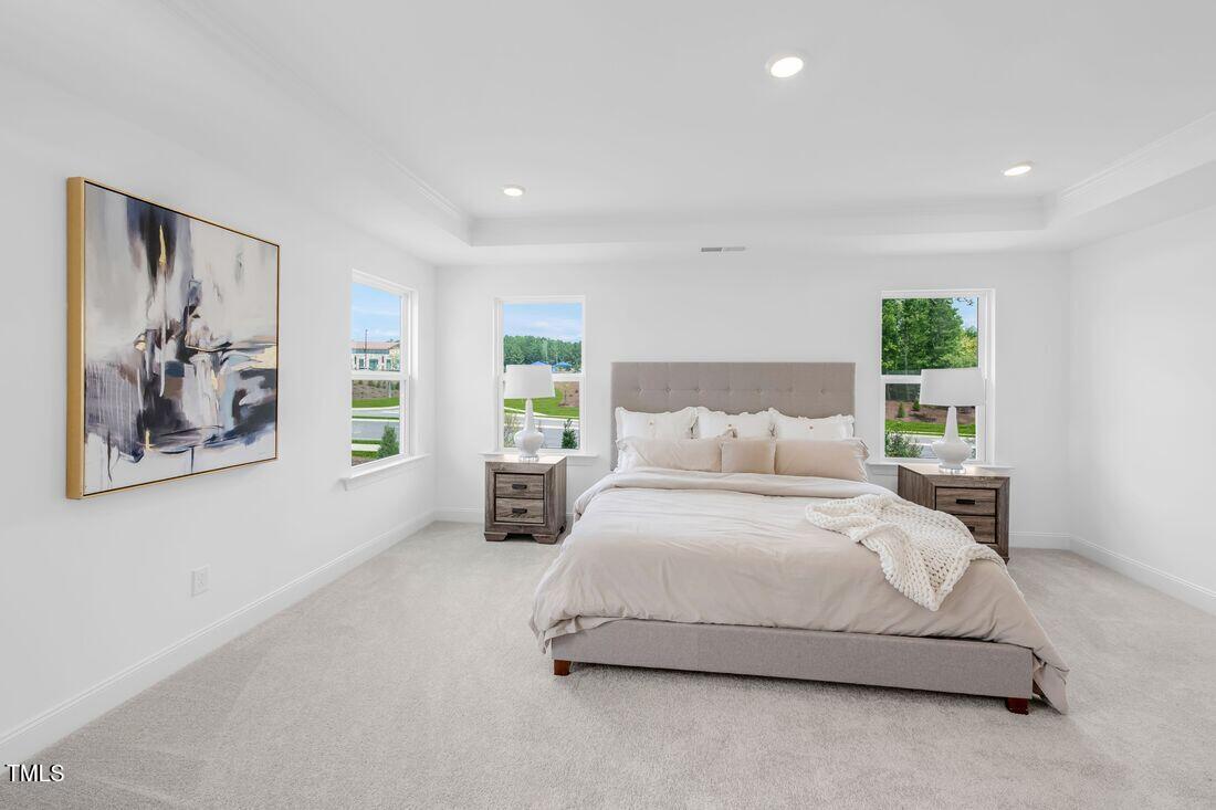 249 Tidal Pool Way Cary, NC 27519 - Photo 6 of 23 a spacious bedroom with a balcony a bed and a painting on the wall
