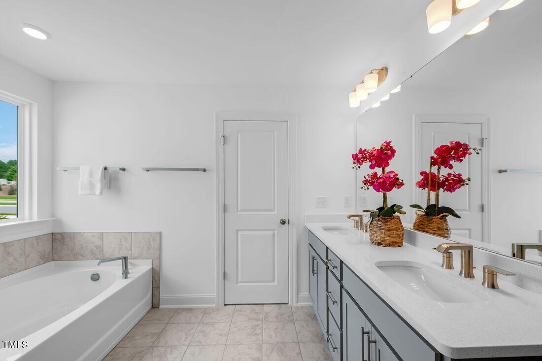 249 Tidal Pool Way Cary, NC 27519 - Photo 9 of 23 a bathroom with a tub sink and mirror