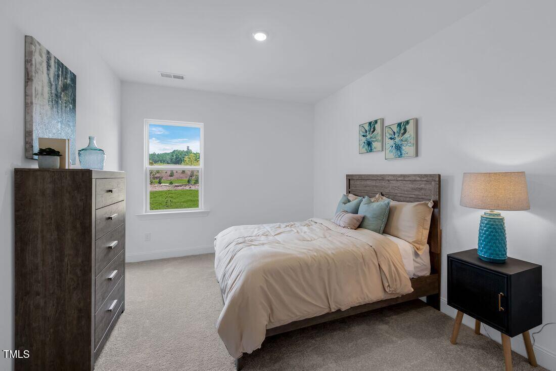 249 Tidal Pool Way Cary, NC 27519 - Photo 10 of 23 a bedroom with a bed and a window