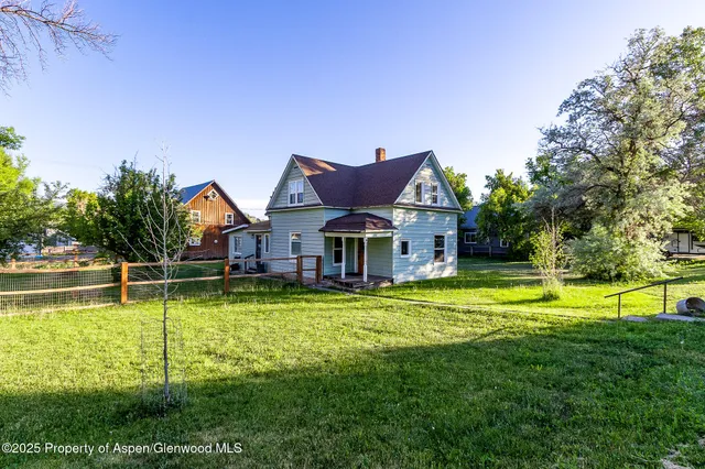 a view of a house with swimming pool and a yard