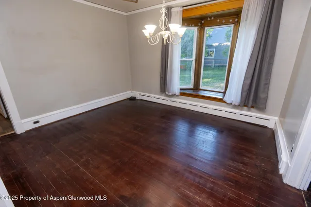 a view of a livingroom with wooden floor and a window